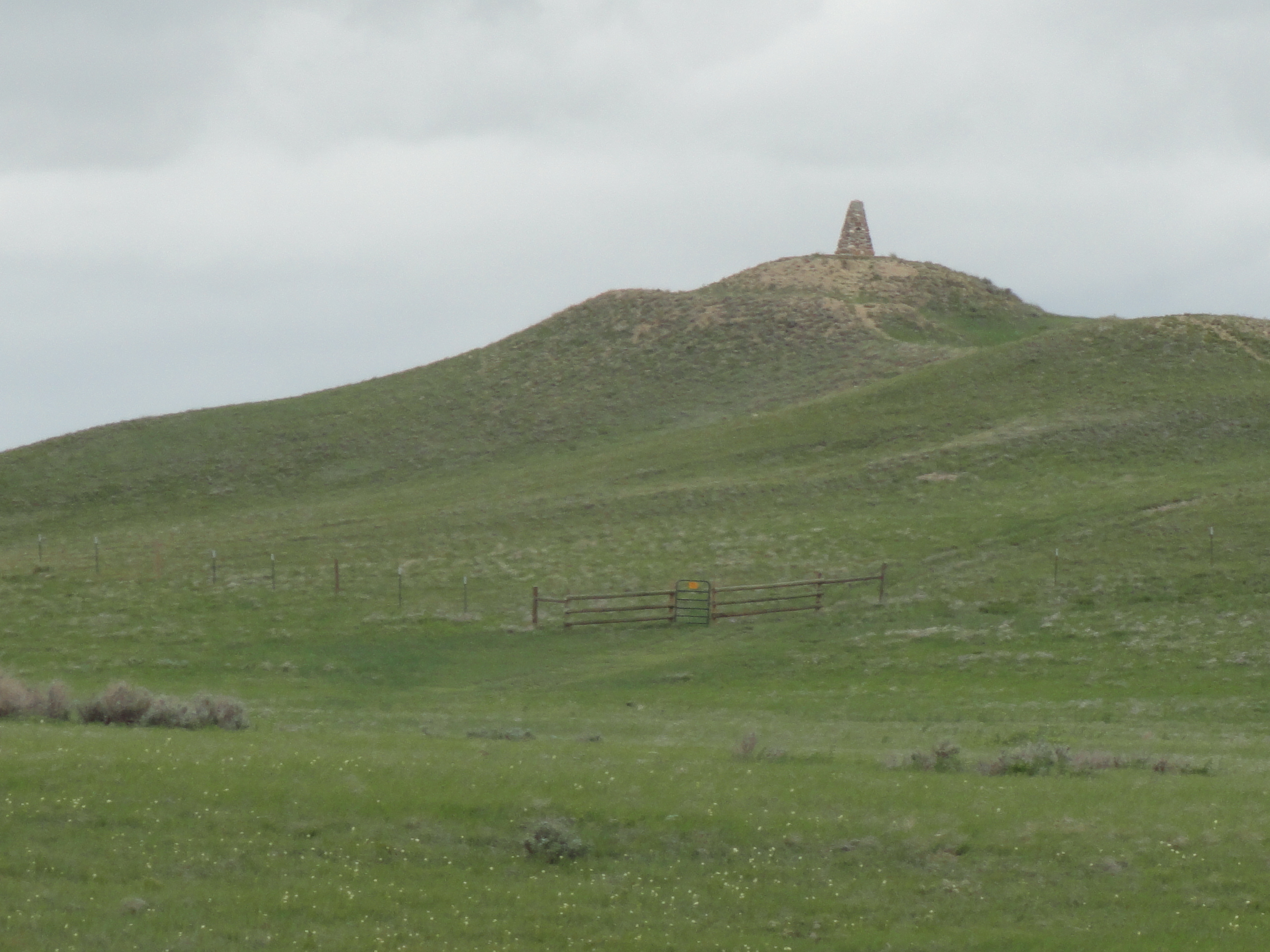 The memorial sits alone atop a windswept hill